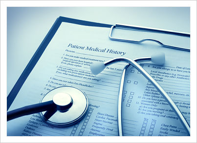 A stethoscope is placed on top of a patient medical history form