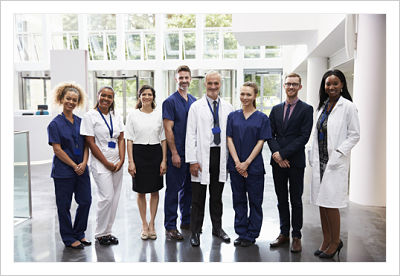 An image of women and men dressed in professional and medical attire