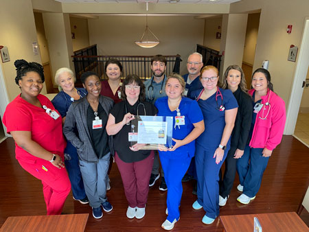 Photo ID from left: Trinity Atkins, PCT, Elisha Smith, RN, Regina Buckmon, PCT, Madison Long, RN, Melanie Brant, NP, Taylor Lyons, PCT, Michael Daly, NP, Director of Hospitalist Services, Whitney Rogers, RN, David Linder, RN, ICU Manager, Hannah Welch, RN, MedSurg Manager, and Meagan Youmans, RN.From left: Trinity Atkins, PCT, Elisha Smith, RN, Regina Buckmon, PCT, Madison Long, RN, Melanie Brant, NP, Taylor Lyons, PCT, Michael Daly, NP, Director of Hospitalist Services, Whitney Rogers, RN, David Linder, RN, ICU Manager, Hannah Welch, RN, MedSurg Manager, and Meagan Youmans, RN.